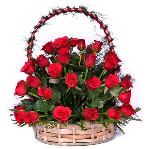 24 Red Roses in Round Wicker Flower Basket - Flower Delivery in GiftsGhaziabad