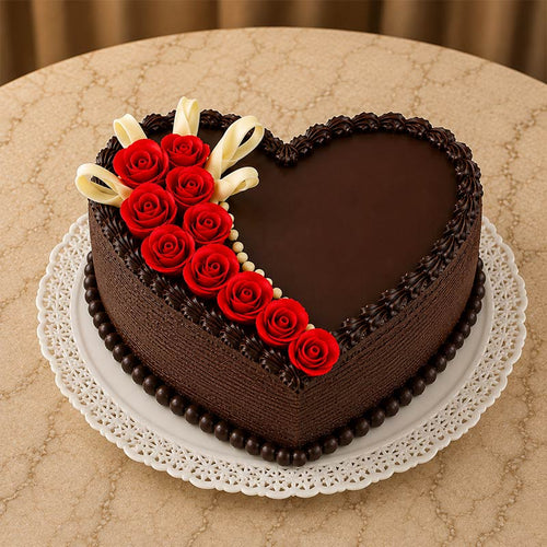 Heart-shaped chocolate cake with red roses on a beige surface