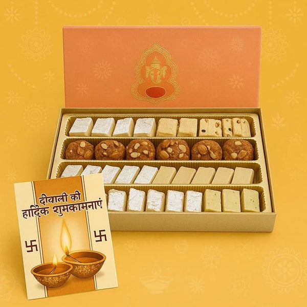 Assorted Indian sweets gift box with Diwali greeting card on festive yellow background