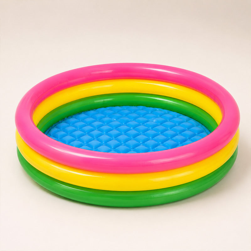 Colorful inflatable pool with pink, yellow, and green rings on a beige background