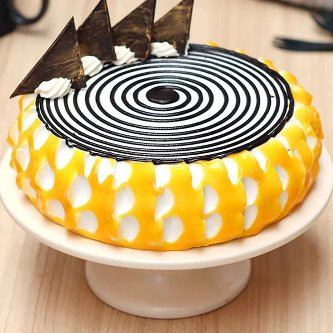 Mango Glaze Cake 1 Kg with Chocolate Spiral Design - Cake Delivery in GiftsGhaziabad