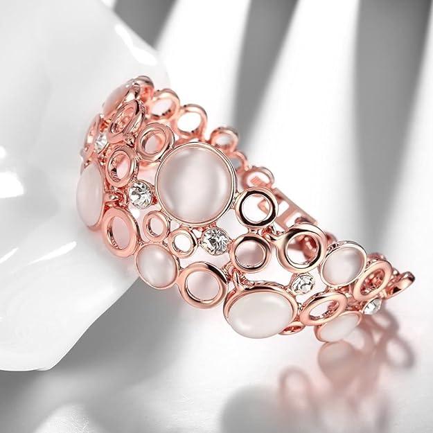 Rose gold bracelet with circular design on a white background