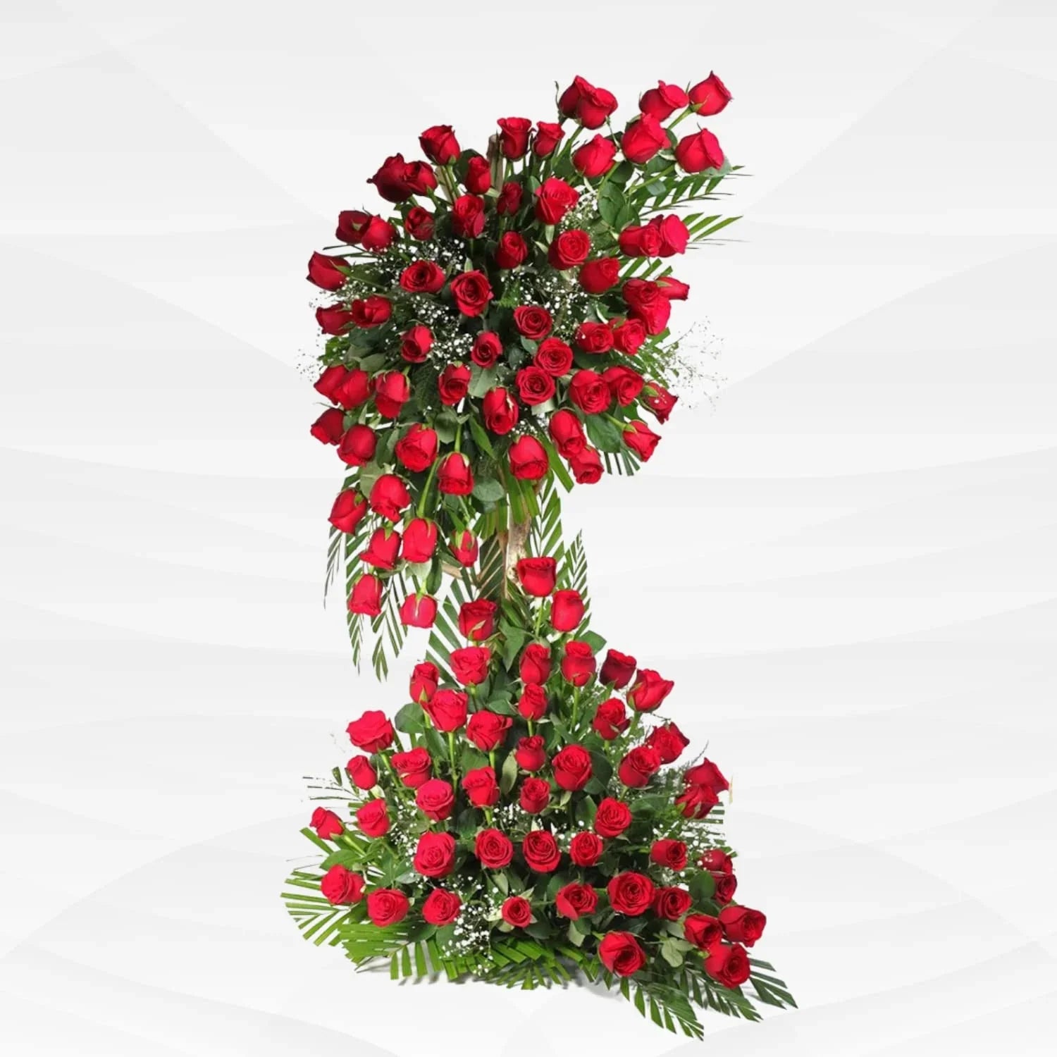 Large two-tier red rose flower arrangement with green leaves on white background