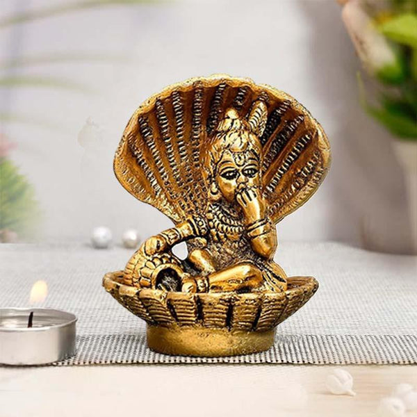 Golden baby Krishna idol with peacock feather, sitting in decorative shell, ideal for gifting