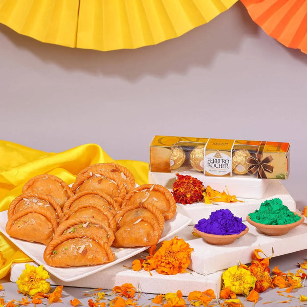 Traditional Indian snacks with Ferrero Rocher chocolates and colorful powders on a decorative background.