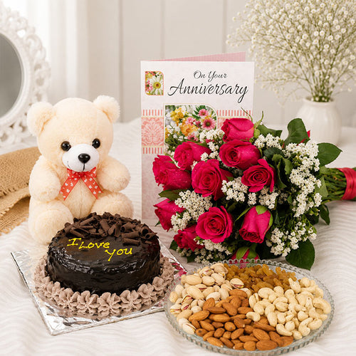 Anniversary gift set with teddy bear, cake, flowers, and dry fruits on a table.