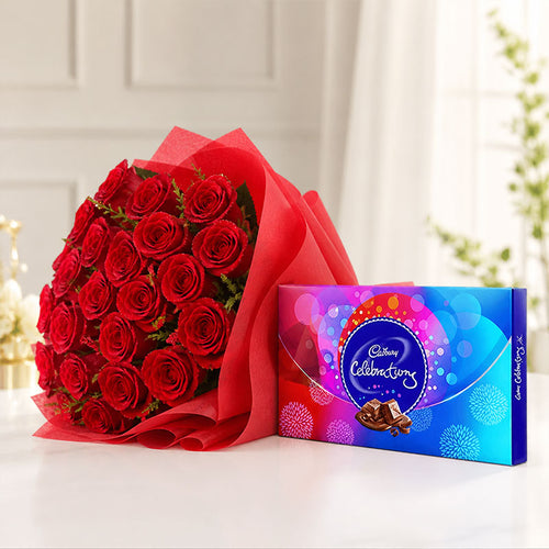 Bouquet of red roses and Cadbury Celebrations chocolate box on a white surface.