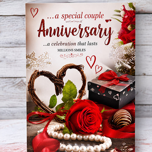 Greeting card for an anniversary celebration with decorative elements like a heart, gift box, and red rose.