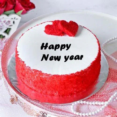 Red and white cake with 'Happy New Year' text on a decorative plate.