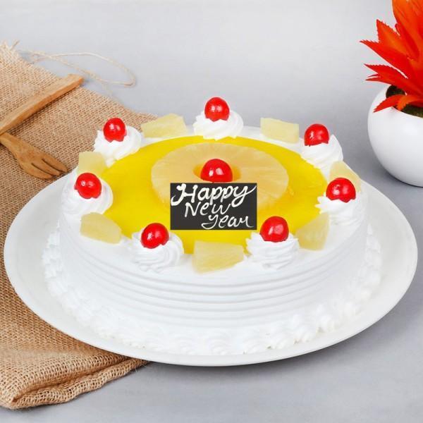 Decorative cake with 'Happy New Year' message on a white plate.