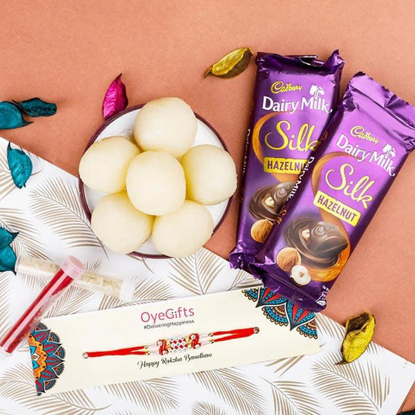 Two Cadbury Dairy Milk Silk Hazelnut chocolate bars with a bowl of white eggs on a decorative background.