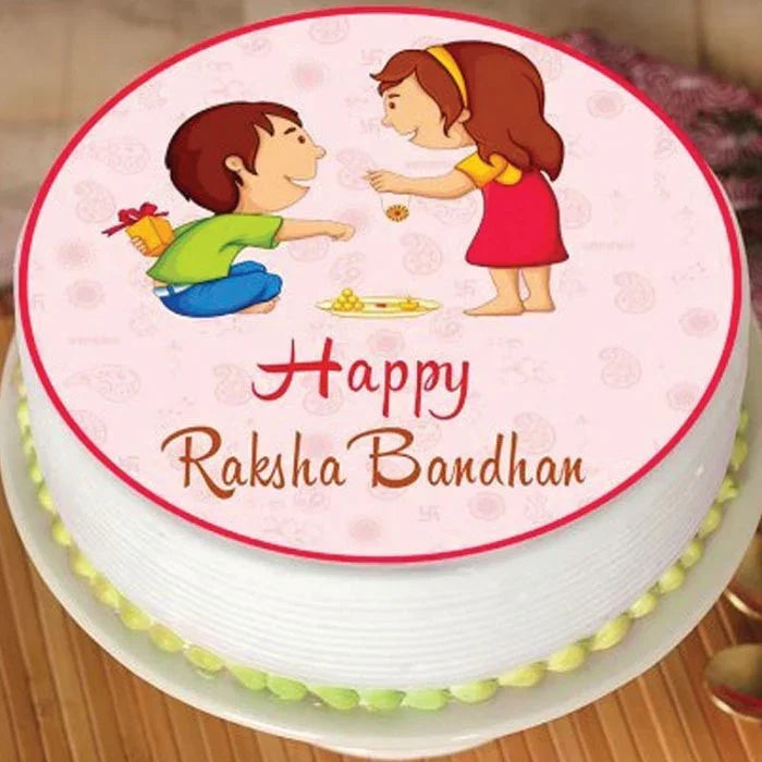 Cake with illustrations of a boy and girl, and 'Happy Raksha Bandhan' text on a pink background.