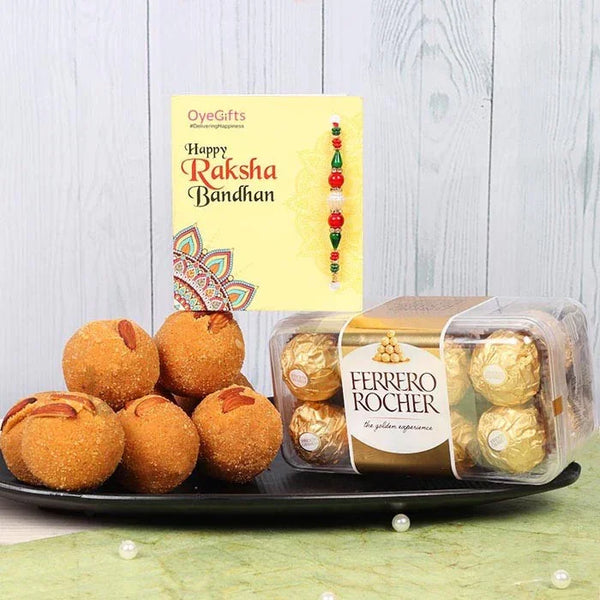 Ferrero Rocher chocolates and ladoos on a plate with a Raksha Bandhan card in the background.