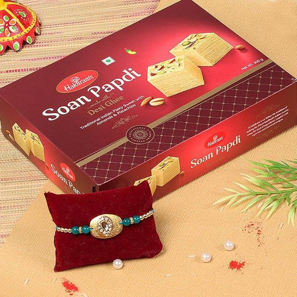 Haldiram's Soan Papdi box with a decorative bracelet on a textured surface