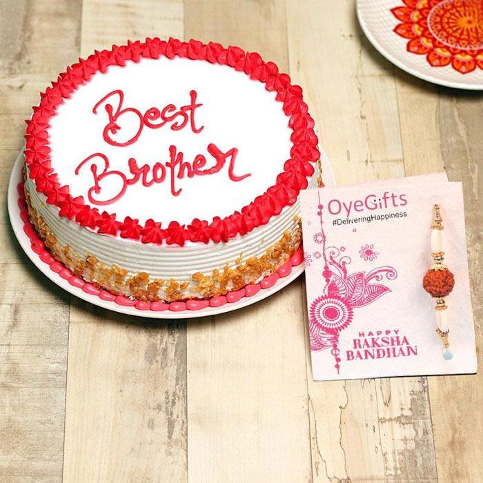 Cake with 'Best Brother' text and a Raksha Bandhan card on a wooden surface