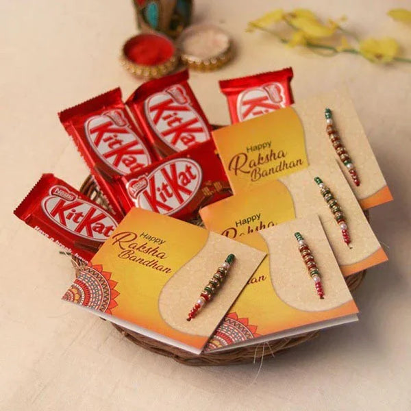 Bowl with KitKat chocolate bars and 'Happy Raksha Bandhan' cards on a beige background