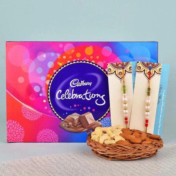 Cadbury Celebration chocolate box with a basket of dry fruits and two cards on a light gray background