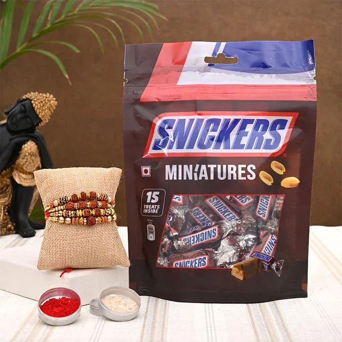 Snickers minatures packaging with a decorative pillow and small bowls on a table.