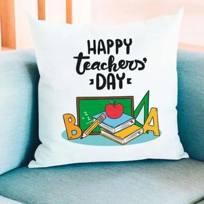 Pillow with 'Happy Teachers' Day' text and educational graphics on a blue couch.