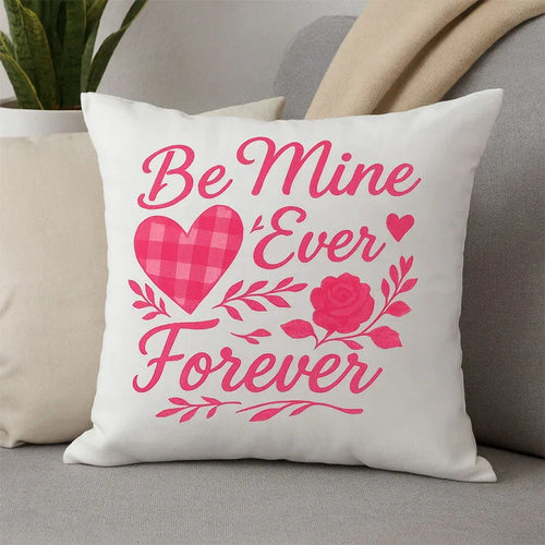 Decorative pillow with 'Be Mine Ever Forever' text and hearts on a couch.