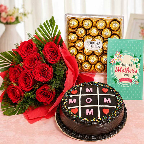 Bouquet of red roses, Ferrero Rocher chocolates, cake with 'MOM' text, and Mother's Day card on a table.