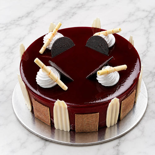 Chocolate cake with decorative elements on a marble surface