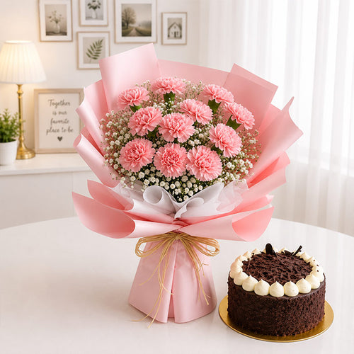 Bouquet of pink flowers wrapped in pink paper with a chocolate cake on a white surface.