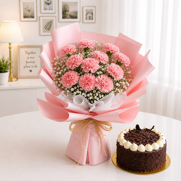 Bouquet of pink flowers wrapped in pink paper with a chocolate cake on a white surface.
