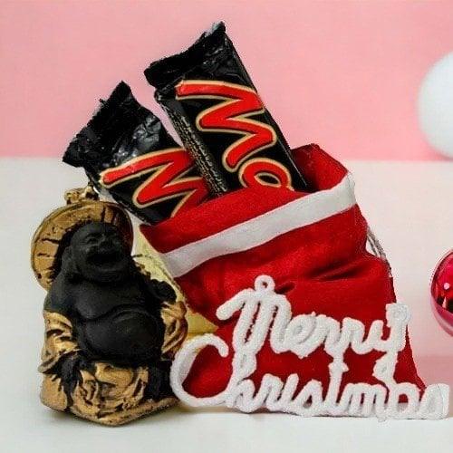 Chocolates in a red gift pouch with Merry Christmas sign and Laughing Buddha statue