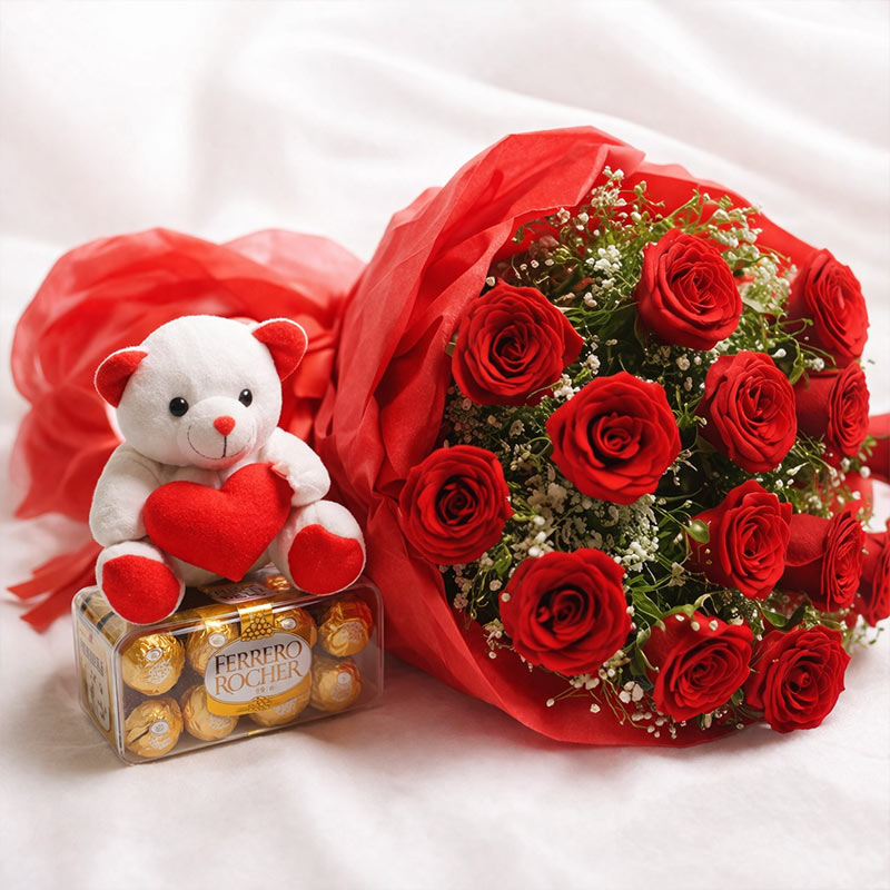 Bouquet of red roses, teddy bear with heart, and Ferrero Rocher chocolates on a white background