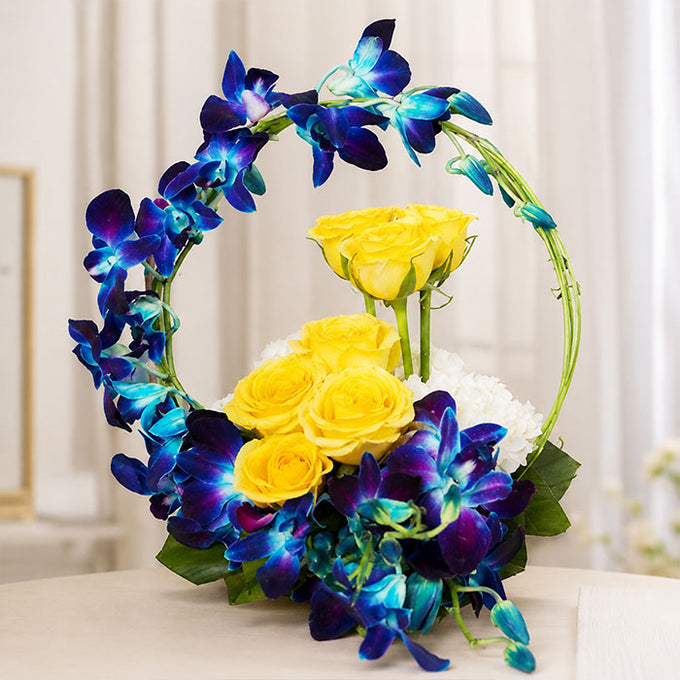 Blue Orchid Arrangement with 7 Yellow Roses & White Carnations