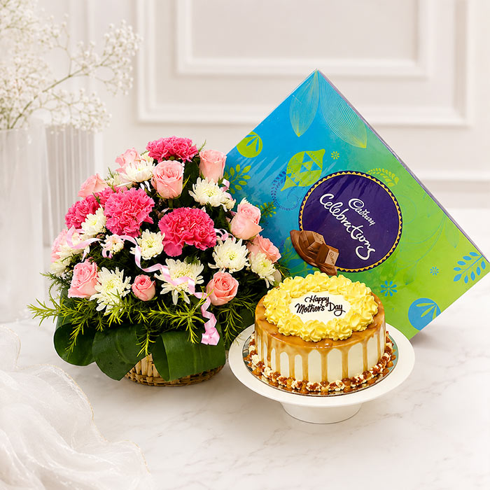 Floral arrangement and cake with a card on a white surface