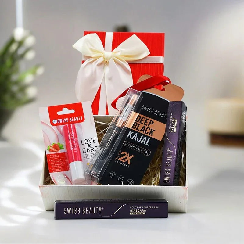 Gift box with beauty products including a red lip balm, white cream, and black kajal, tied with a white ribbon.