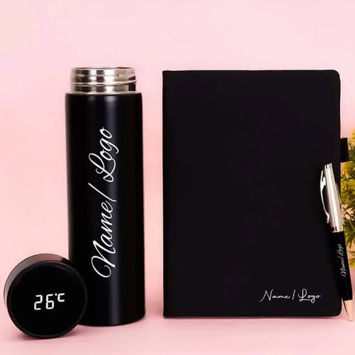 Black thermos, black notebook with pen, and digital thermometer on a pink background