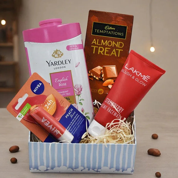 Gift box with Yardley talc, Cadbury chocolate, Lakme facewash, and Nivea lip balm.