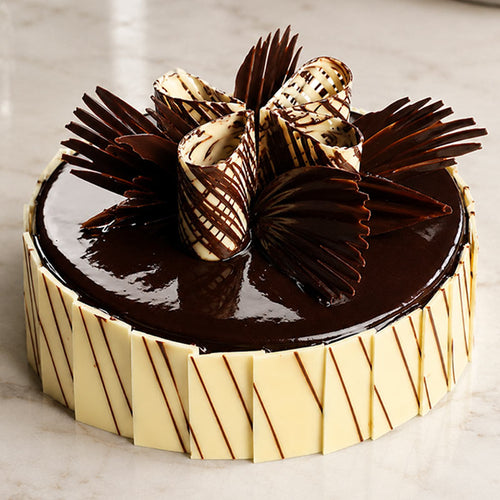 Chocolate cake with decorative elements on a marble surface
