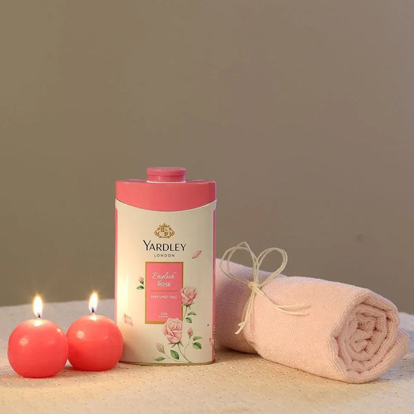 Pink Yardley English Rose talcum powder, rolled towel, and two pink candles, spa gift set