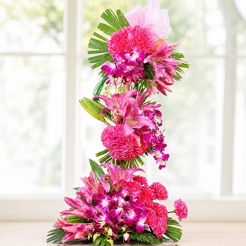 Floral arrangement with pink and green flowers on a white background