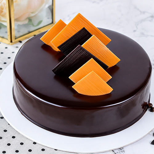 Chocolate cake with orange and brown decorative elements 