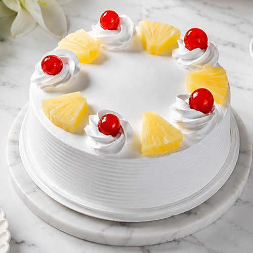 Decorative cake with pineapple slices and cherries 