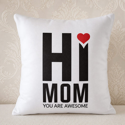 White pillow with 'HI MOM YOU ARE AWESOME' text and a red heart on a decorative wall background.