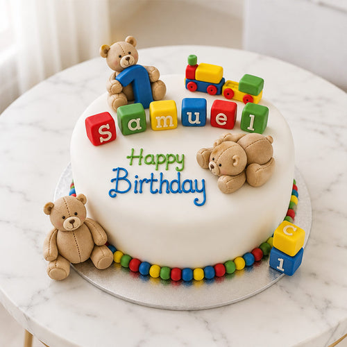 Birthday cake with teddy bears and colorful blocks on a marble surface