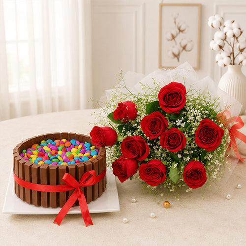 Chocolate cake with colorful candies and red roses on a table.