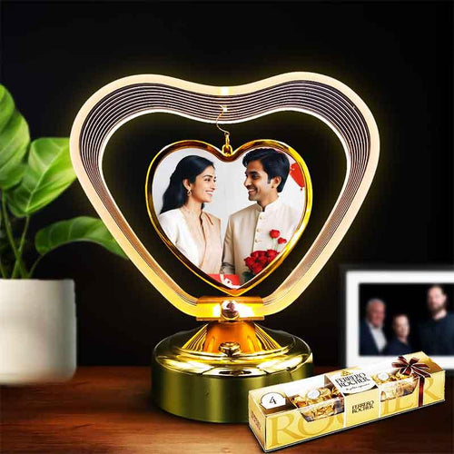 Heart-shaped photo frame light with a couple's photo inside, placed on a wooden surface with a dark background.