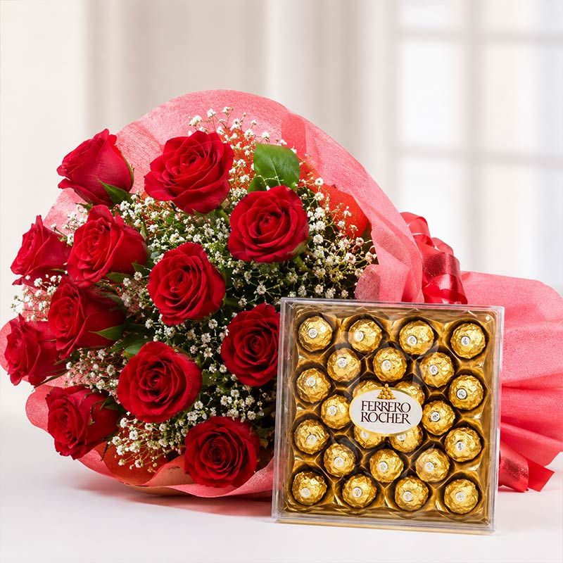 Bouquet of red roses with a box of Ferrero Rocher chocolates on a white background