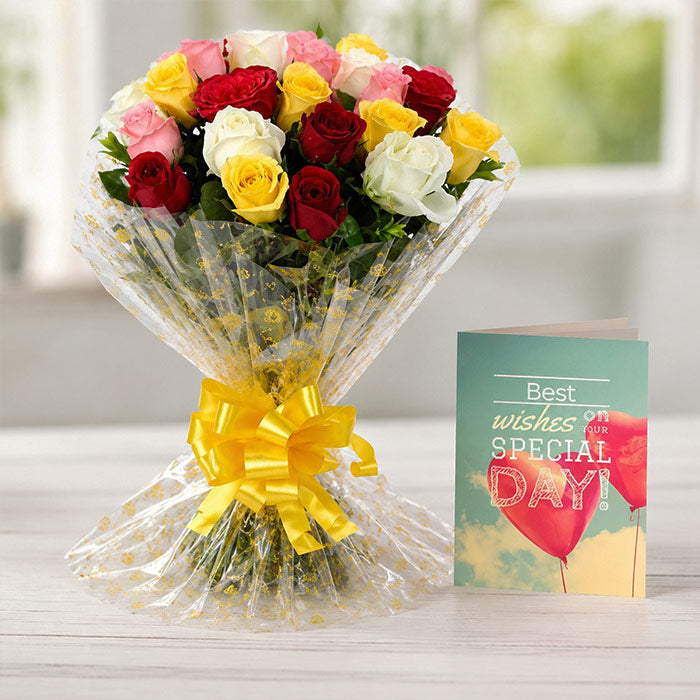 Bouquet of colorful roses with a 'Best wishes for your special day' card on a light surface.