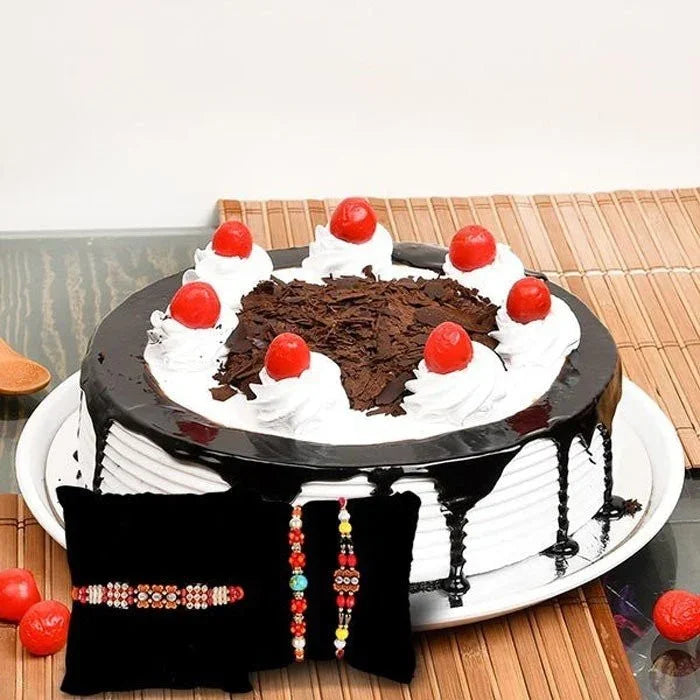 Chocolate cake with white frosting and red cherries on a wooden table.