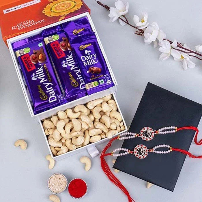 Set Of 2 Silver Om Rakhi With Cashews And Chocolates