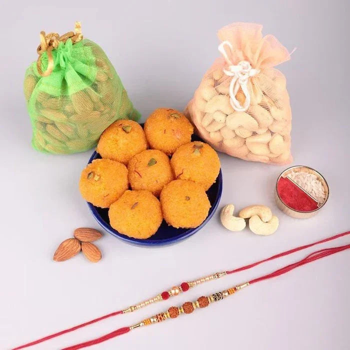 Assorted snacks including oranges, cashews, and a bowl of round snacks on a light gray background.