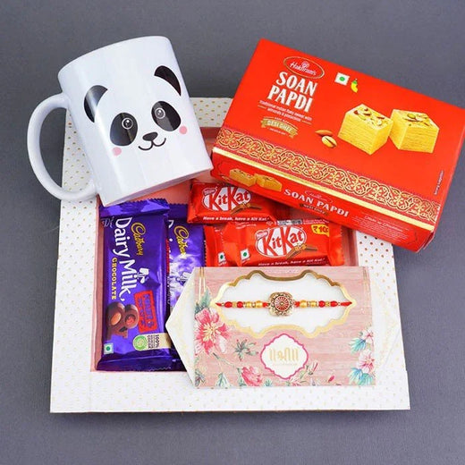 Assorted snacks and a mug on a gray background
